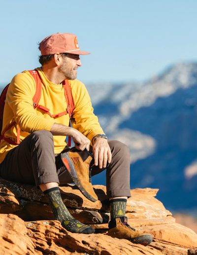 A man wearing a pair of yarn goblin micro crew lightweight Darn Tough hiking sock
