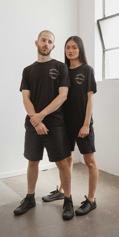 A couple wearing black classic unisex organic cotton t-shirt from Kodama