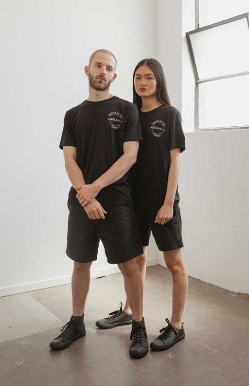 A couple wearing black classic unisex organic cotton t-shirt from Kodama