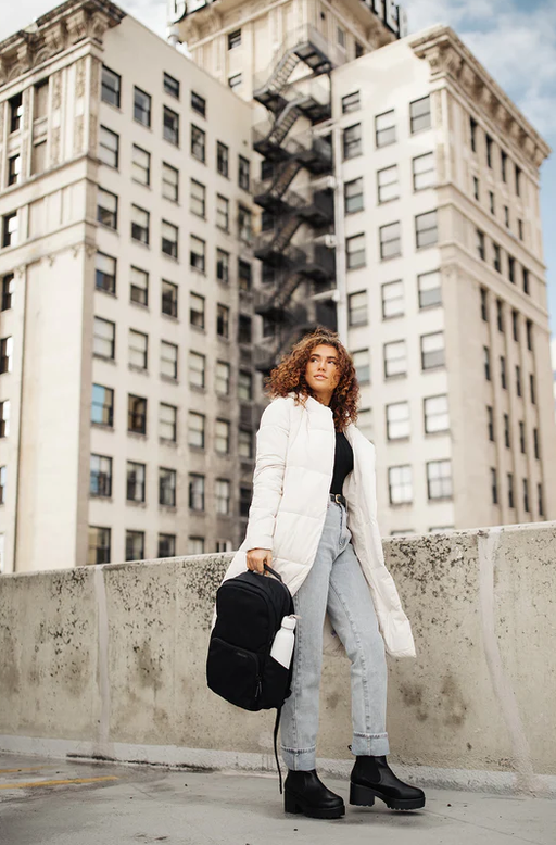 A woman with black brevitē backpack