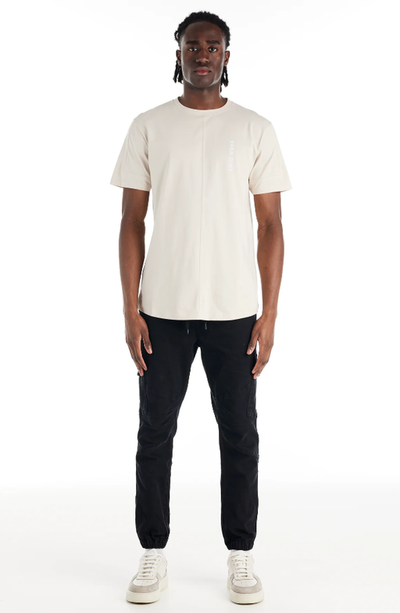 A man wearing a Nana Judy saint t-shirt in white