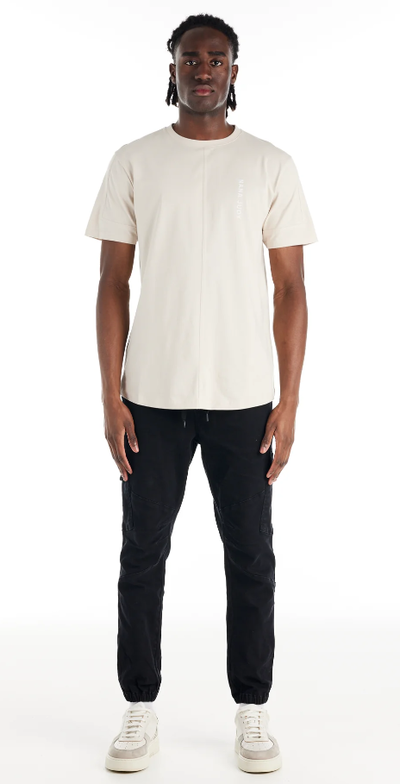 A man wearing a Nana Judy saint t-shirt in white
