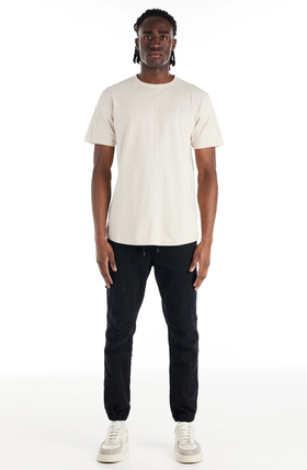 A man wearing a Nana Judy saint t-shirt in white