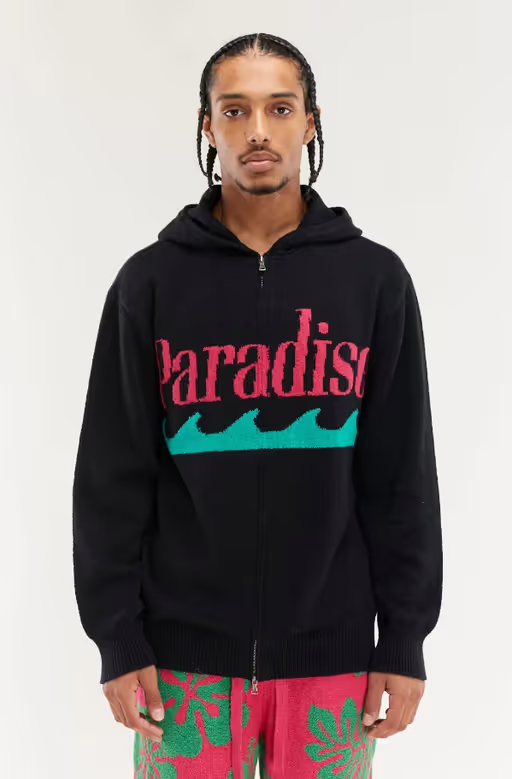 A man wearing black & flamingo paradise zip hoodie by The Elder Statesman