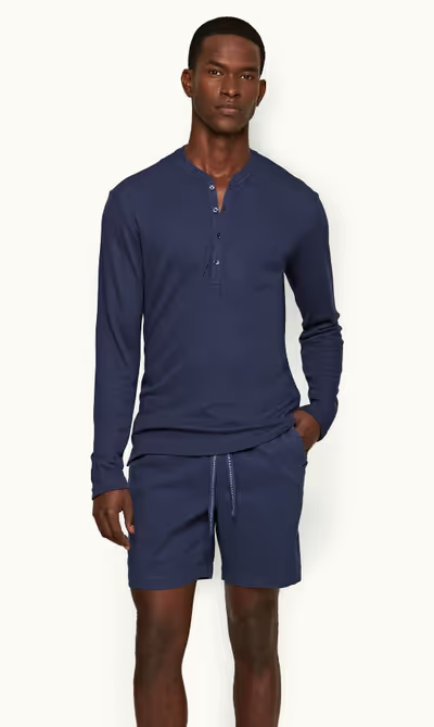 A man wearing lagoon blue classic fit long-sleeve cashmere t-shirt by Orlebar Brown