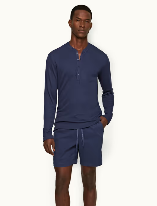 A man wearing lagoon blue classic fit long-sleeve cashmere t-shirt by Orlebar Brown