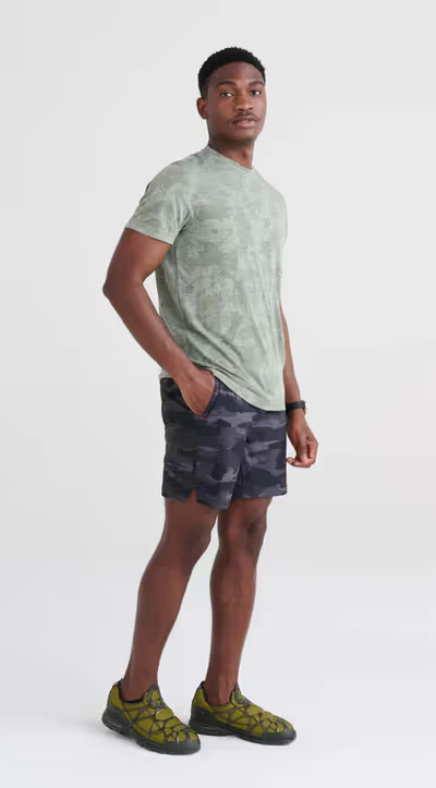 A man wearing short sleeve crew / tar green camo by Saxx