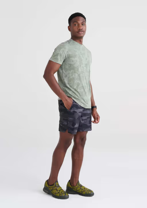 A man wearing short sleeve crew / tar green camo by Saxx