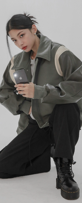 A woman wearing a Norda varsity leather sleeve