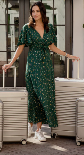 A woman with multiple Arlo Skye suitcases in beige