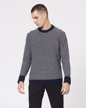 A man wearing a Jack London striped long-sleeve with black pants