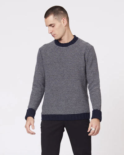 A man wearing a Jack London striped long-sleeve with black pants