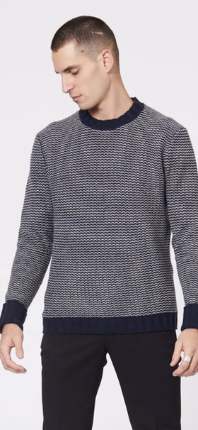 A man wearing a Jack London striped long-sleeve with black pants