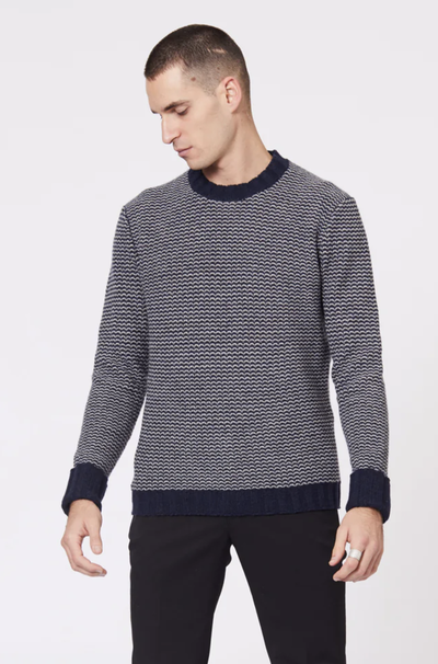A man wearing a Jack London striped long-sleeve with black pants