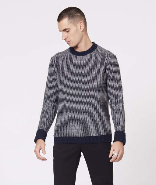 A man wearing a Jack London striped long-sleeve with black pants