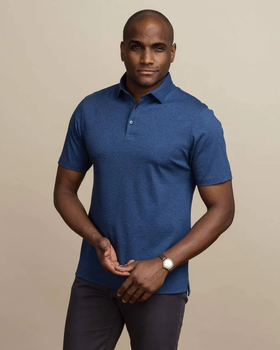 A man wearing the dark blue heather arlon knit custom polo by Ledbury