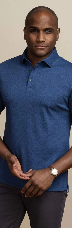 A man wearing the dark blue heather arlon knit custom polo by Ledbury