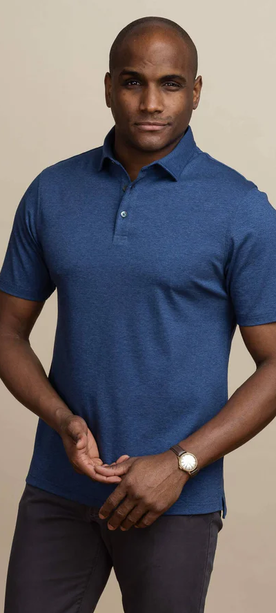 A man wearing the dark blue heather arlon knit custom polo by Ledbury