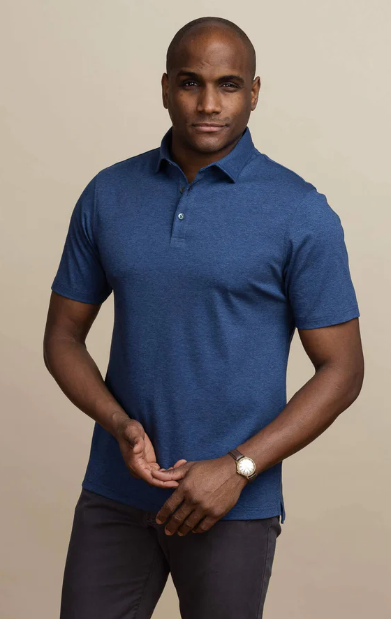 A man wearing the dark blue heather arlon knit custom polo by Ledbury