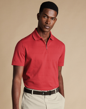 A man wearing popcorn textured tyrwhitt cool zip-neck stripe polo by Charles Tywhitt