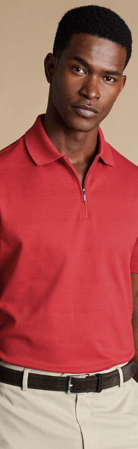 A man wearing popcorn textured tyrwhitt cool zip-neck stripe polo by Charles Tywhitt