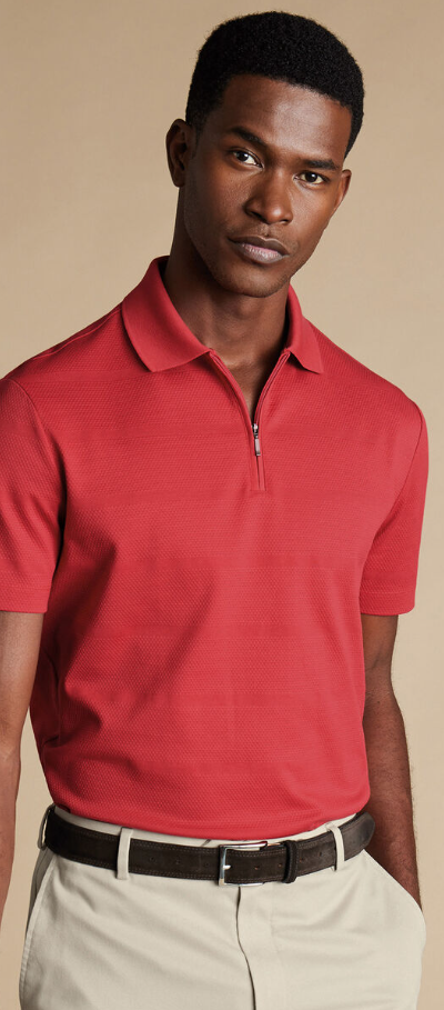 A man wearing popcorn textured tyrwhitt cool zip-neck stripe polo by Charles Tywhitt