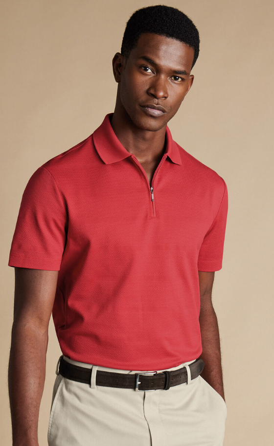 A man wearing popcorn textured tyrwhitt cool zip-neck stripe polo by Charles Tywhitt
