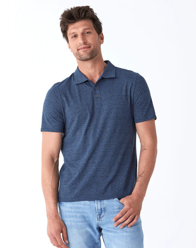 A man wearing a Threads 4 Thought black fleck triblend jersey polo