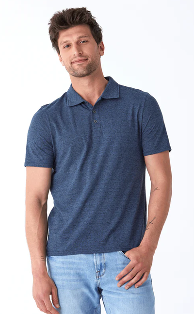 A man wearing a Threads 4 Thought black fleck triblend jersey polo