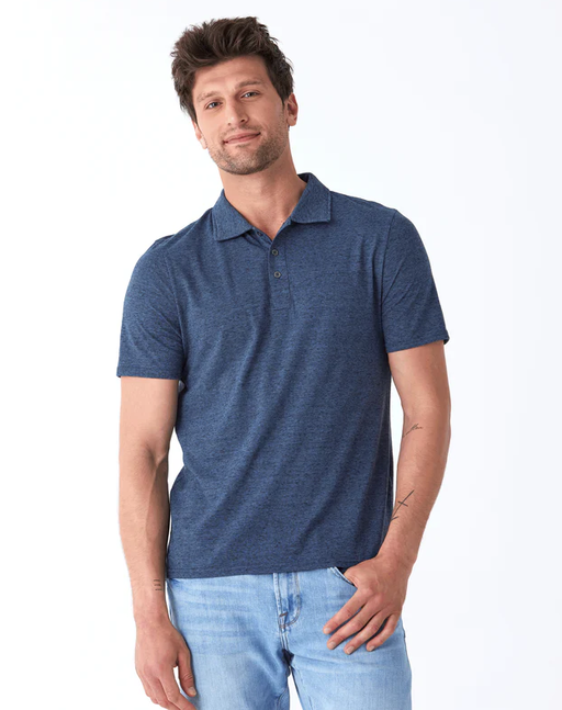 A man wearing a Threads 4 Thought black fleck triblend jersey polo
