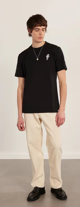 A man wearing a Percival black spaceman auxiliary t shirt