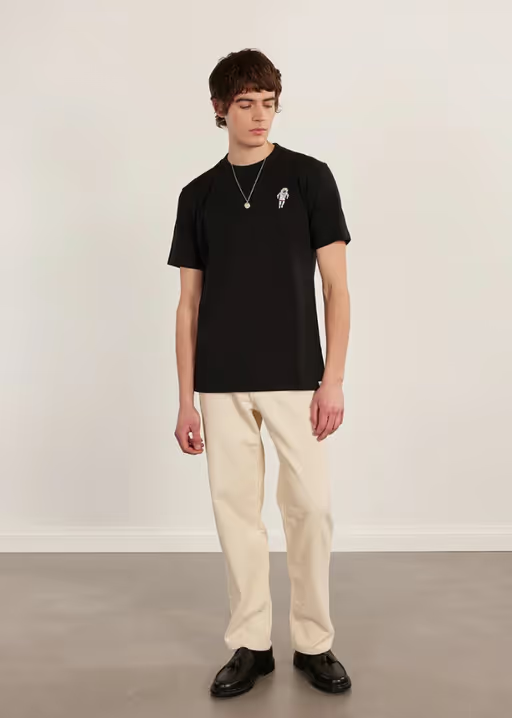 A man wearing a Percival black spaceman auxiliary t shirt