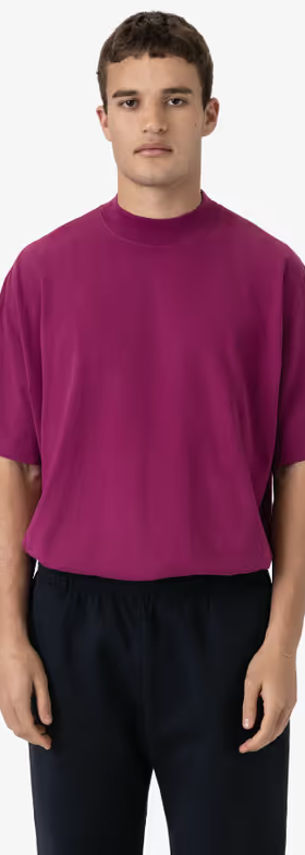 A man wearing a Los Angeles Apparel ruby color oversized short sleeve high mockneck t-shirt