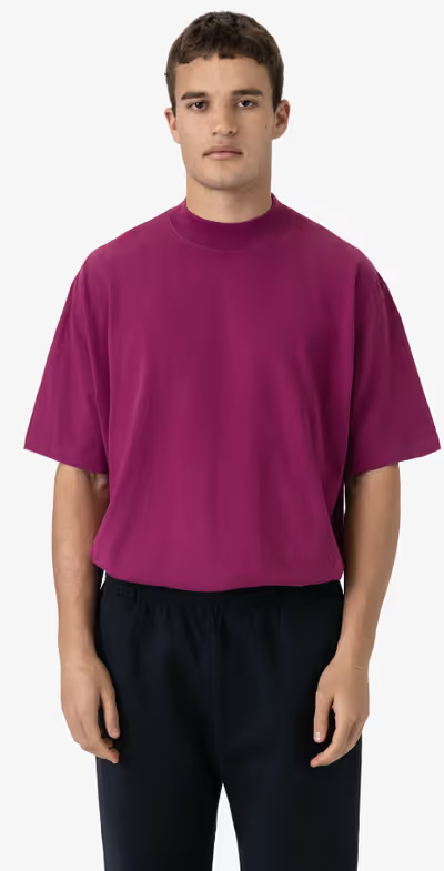 A man wearing a Los Angeles Apparel ruby color oversized short sleeve high mockneck t-shirt