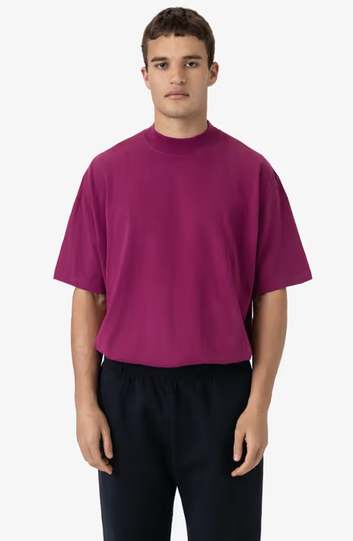 A man wearing a Los Angeles Apparel ruby color oversized short sleeve high mockneck t-shirt
