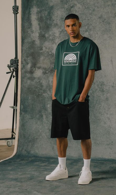 A man wearing a South Pole green t-shirt