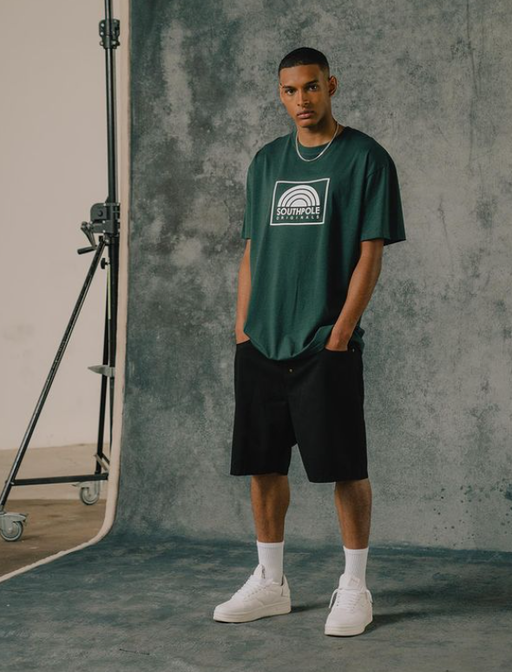 A man wearing a South Pole green t-shirt