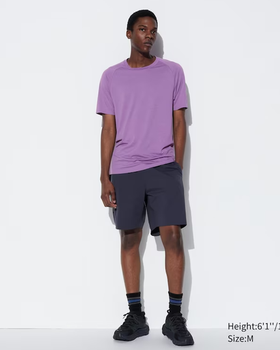 A man wearing a Kaws dry-ex short sleeve purple t-shirt