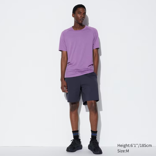 A man wearing a Kaws dry-ex short sleeve purple t-shirt