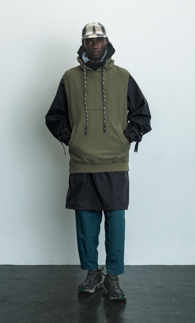 A man wearing a F/CE pertex waterproof coat