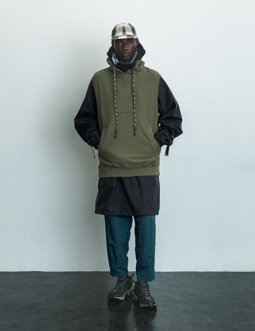 A man wearing a F/CE pertex waterproof coat