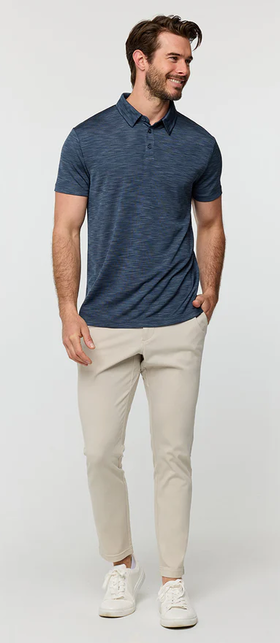 A man wearing a Into The Am navy color performance polo - non-branded