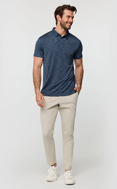 A man wearing a Into The Am navy color performance polo - non-branded