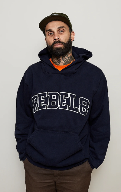 A man wearing a Rebel8 navy blue hoodie