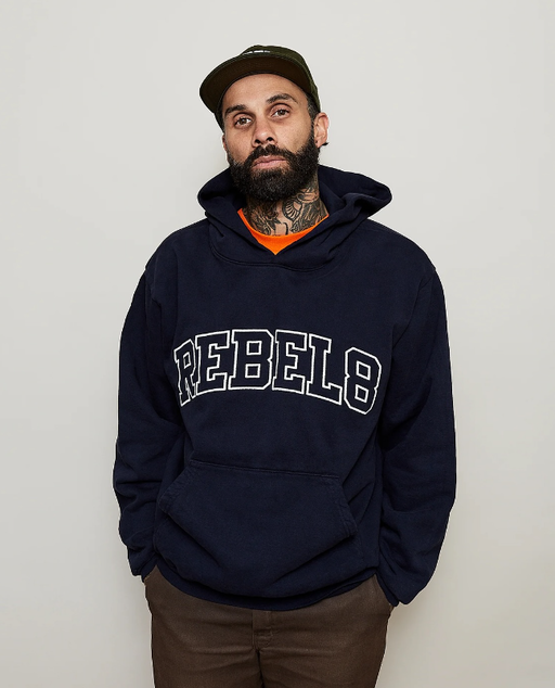 A man wearing a Rebel8 navy blue hoodie