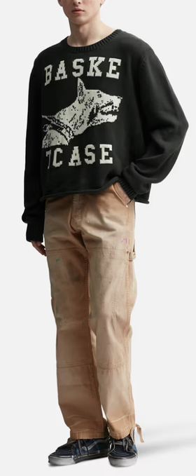 A man wearing a BasketCase raw college knit black sweater