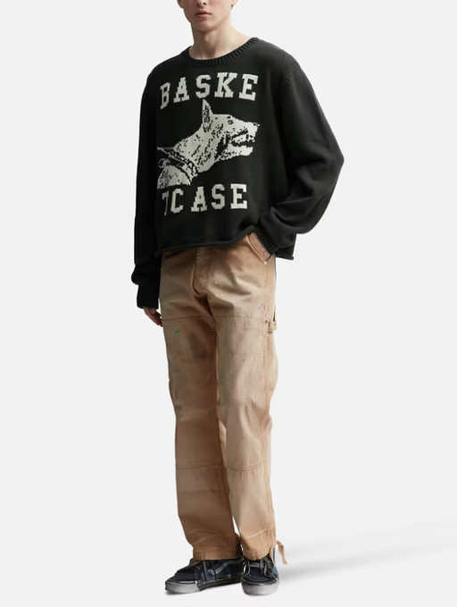 A man wearing a BasketCase raw college knit black sweater