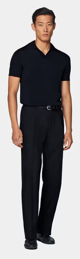 A man wearing a SuitSupply navy buttonless polo