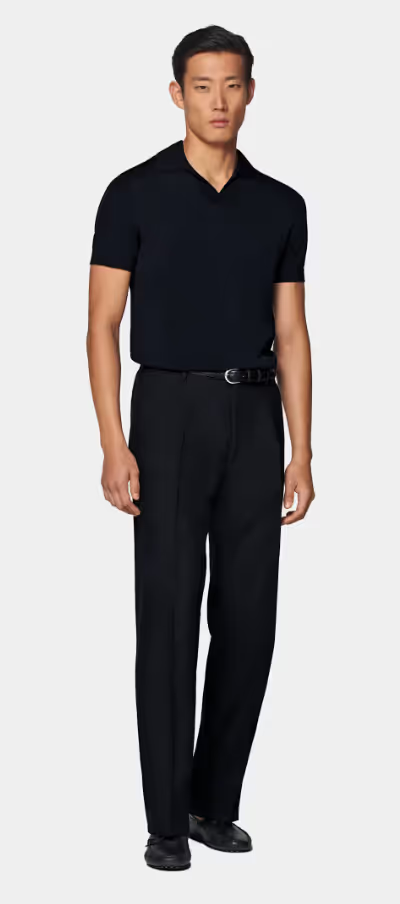 A man wearing a SuitSupply navy buttonless polo
