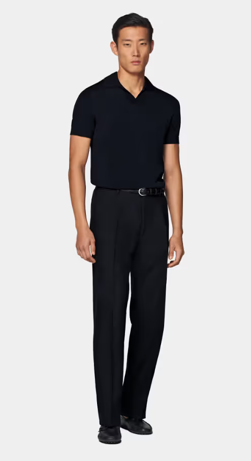 A man wearing a SuitSupply navy buttonless polo